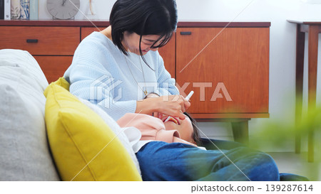 Image of a mother brushing her teeth Image of a mother brushing her teeth 139287614