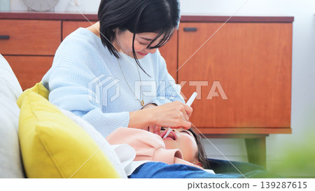 Image of a mother brushing her teeth Image of a mother brushing her teeth 139287615