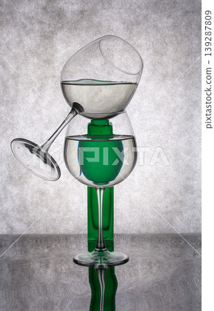Still life with a green vase and a glass of liquid Still life with a green vase and a glass of liquid 139287809