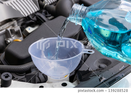 I'm opening the hood of my car and refilling the windshield washer fluid. 139288528