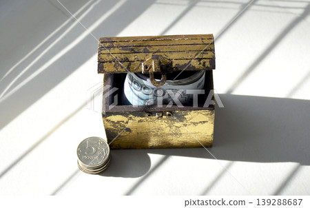 A wooden chest containing coins and Russian rubles. A wooden chest containing coins and Russian rubles. 139288687
