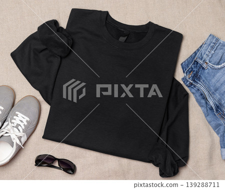 Blank black unisex sweatshirt mockup, folded flat lay with denim shorts and grey sneakers, top view Blank black unisex sweatshirt mockup, folded flat lay with denim shorts and grey sneakers, top view 139288711