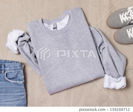 Sport grey unisex sweatshirt mockup, folded flat lay with denim shorts and grey sneakers, top view Sport grey unisex sweatshirt mockup, folded flat lay with denim shorts and grey sneakers, top view 139288712