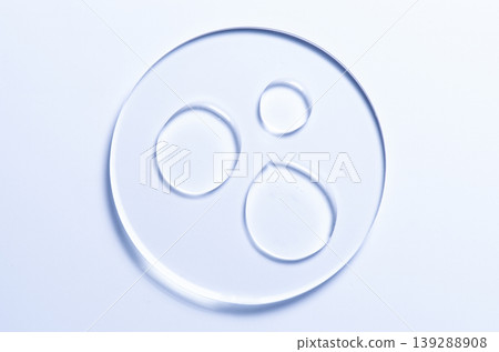 Skin serum or moisturizer or shower gel on a glass circle. A cosmetic product for body care. Skin serum or moisturizer or shower gel on a glass circle. A cosmetic product for body care. 139288908