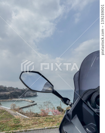 A motorcycle and scenery resting on a hill overlooking the sea. A motorcycle and scenery resting on a hill overlooking the sea. 139289001