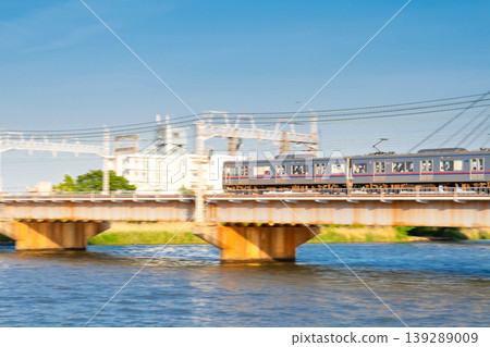 Keisei Main Line 3000 series train crossing the Nakagawa Bridge, panning shot. Keisei Main Line 3000 series train crossing the Nakagawa Bridge, panning shot. 139289009