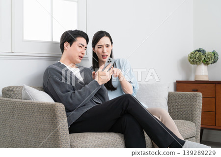 Young men and women searching on their smartphones: Lifestyle image Young men and women searching on their smartphones: Lifestyle image 139289229
