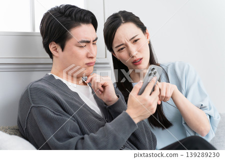 Young men and women searching on their smartphones: Lifestyle image Young men and women searching on their smartphones: Lifestyle image 139289230