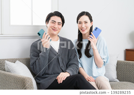 Young men and women searching on their smartphones: Lifestyle image 139289235