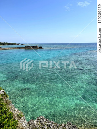 The turquoise blue sea of Okinawa, surrounded by stone breakwaters and reefs. The turquoise blue sea of Okinawa, surrounded by stone breakwaters and reefs. 139289489