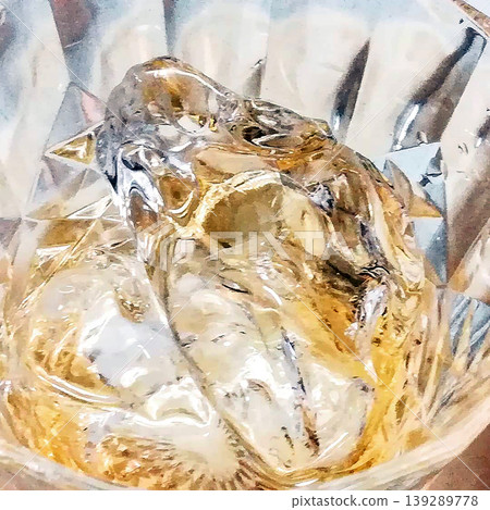 Alcohol in a glass and 1 ice cube 139289778