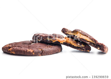 Chocolate Cookies With Caramel Filling Stacked and Broken Bite on White Background Chocolate Cookies With Caramel Filling Stacked and Broken Bite on White Background 139290659