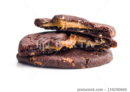 Chocolate Cookies With Caramel Filling Stacked and Broken Bite on White Background 139290660