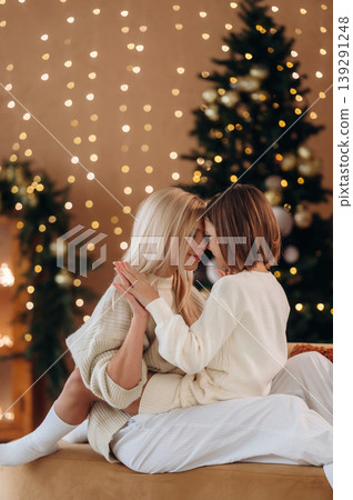 Christmas decorations. Mother and daughter are celebrating New Year at home in domestic room Christmas decorations. Mother and daughter are celebrating New Year at home in domestic room 139291248