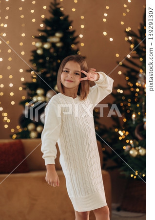 Cute little girl is celebrating New Year at home in domestic room Cute little girl is celebrating New Year at home in domestic room 139291307