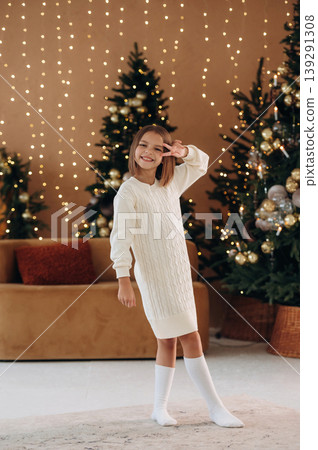 Cute little girl is celebrating New Year at home in domestic room Cute little girl is celebrating New Year at home in domestic room 139291308