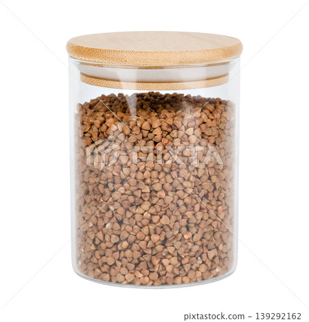Buckwheat in a glass jar with a wooden lid isolated on white background Buckwheat in a glass jar with a wooden lid isolated on white background 139292162