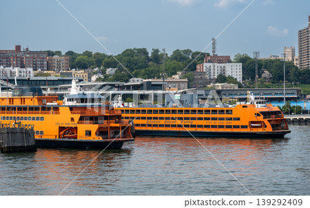 New york, usa august 16,2024. Staten island ferry crossing new york harbor between manhattan and staten island, iconic waterfront commute and sightseeing vessel New york, usa august 16,2024. Staten island ferry crossing new york harbor between manhattan and staten island, iconic waterfront commute and sightseeing vessel 139292409