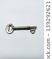 Top view of a single vintage metal key isolated on a white background. 139292621