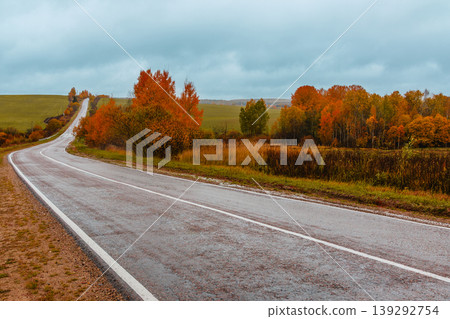 Scenic autumn road winding through colorful trees Scenic autumn road winding through colorful trees 139292754