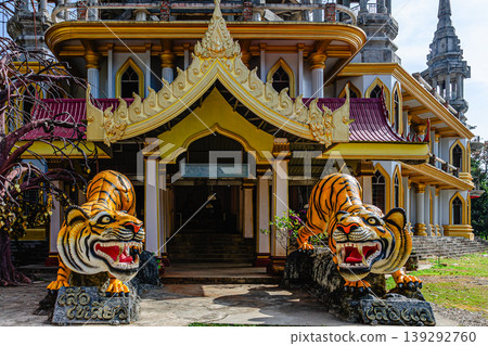 Monumental tiger sculptures guard entrance of temple in Thailand during bright sunny day 139292760
