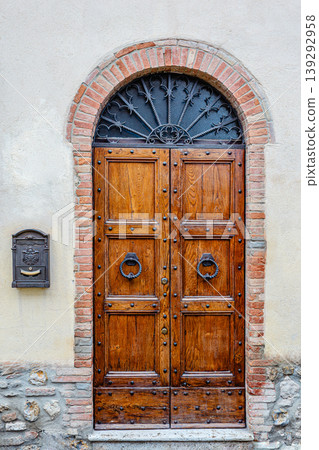 Antique wooden door in an old stone wall of a house 139292958