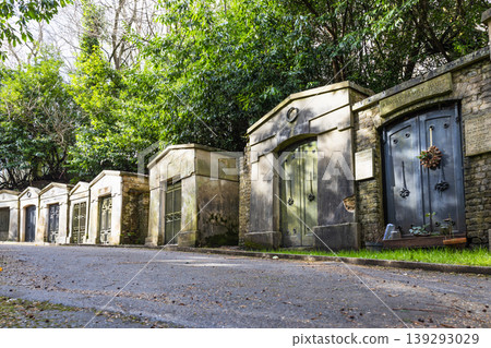Historic stone mausoleums lining a path in Highgate Cemetery Historic stone mausoleums lining a path in Highgate Cemetery 139293029