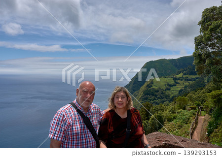 Mature couple appreciating the stunning coastal landscapes at Ponta do Sossego, Azores. 139293153