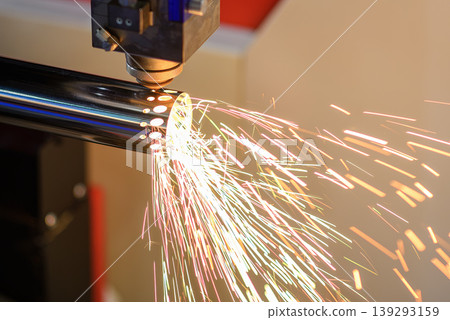 Intense sparkling light from a fiber laser cutting machine processing a stainless steel tube. Intense sparkling light from a fiber laser cutting machine processing a stainless steel tube. 139293159