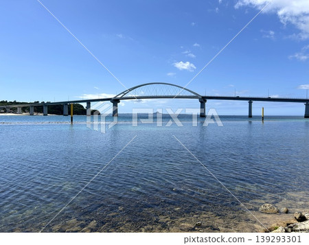 The view of Sesoko Bridge and Ie Island reflected in the blue sea. The view of Sesoko Bridge and Ie Island reflected in the blue sea. 139293301