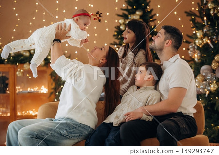 Feeling good. Happy family is celebrating the Christmas in the holidays decorated room 139293747
