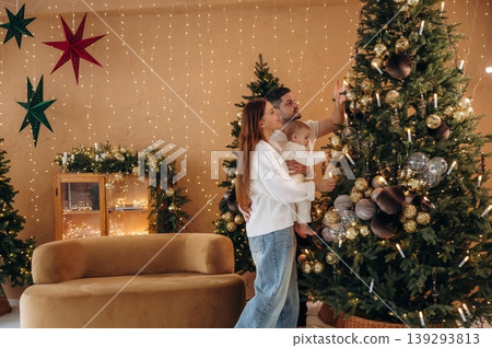 Mother is with her little baby daughter are indoors, celebrating Christmas 139293813