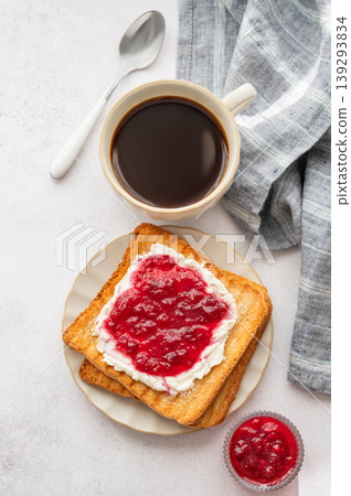 Toast with sweet berry-fruit jam and cream cheese on a plate on a light concrete background Toast with sweet berry-fruit jam and cream cheese on a plate on a light concrete background 139293834