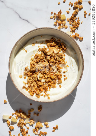 Balanced breakfast with yogurt, granola and spoon on marble background. Top view Balanced breakfast with yogurt, granola and spoon on marble background. Top view 139293850