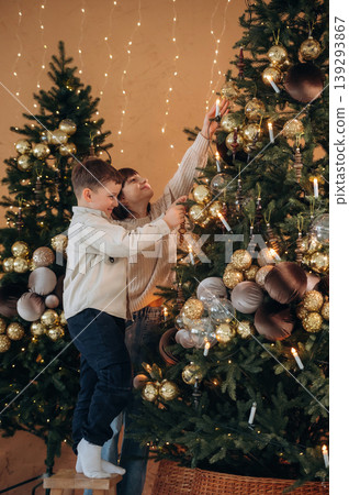 Sister and brother are decorating Christmas tree at home together 139293867