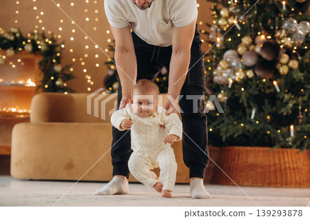 Father with his baby daughter is at home celebrating Christmas Father with his baby daughter is at home celebrating Christmas 139293878