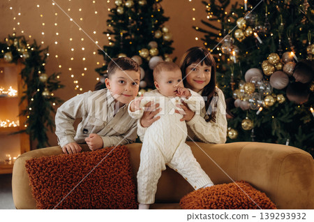 Kids are together, celebrating Christmas in the New year decorated domestic room 139293932