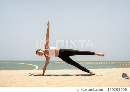 Fit woman practicing yoga on beach, outdoor Fitness and Healthy Lifestyle Concept. 139293996