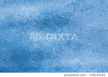 Washed light blue denim fabric texture background with faded cotton weave for casual apparel backdrop 139294262