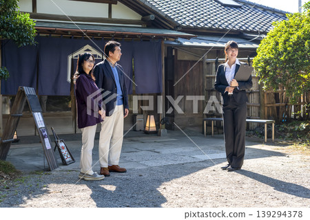 A female guide giving a tour of an old house and a senior couple A female guide giving a tour of an old house and a senior couple 139294378