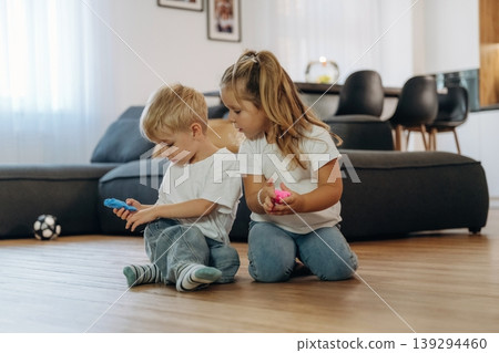 Plasticine in hands. Little kids are playing together in the domestic room at daytime 139294460