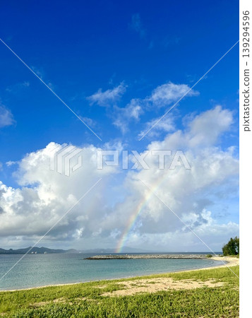 A rainbow appears over 21st Century Forest Beach in the Okinawan summer sky. A rainbow appears over 21st Century Forest Beach in the Okinawan summer sky. 139294596