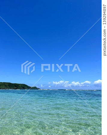 The crystal-clear waters and lush green cape of Adan Beach in Kunigami Village The crystal-clear waters and lush green cape of Adan Beach in Kunigami Village 139294897