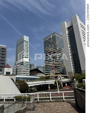 The modern buildings of the Takeshiba area and the blue sky. The Tokyo Bayside cityscape viewed from the wooden deck. 139294904