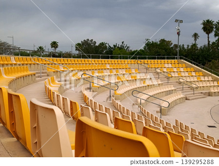 Empty Stadium Seats with Trees in Background Empty Stadium Seats with Trees in Background 139295288