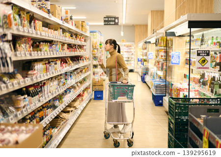 A woman shopping at a supermarket A woman shopping at a supermarket 139295619