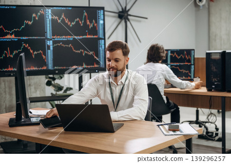 Two male exchange workers are in the office together Two male exchange workers are in the office together 139296257