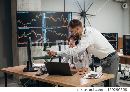 Thinking, talking the strategy. Two male exchange workers are in the office together 139296268