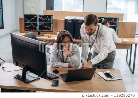 Thinking, talking the strategy. Two male exchange workers are in the office together 139296270