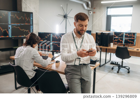 Two male exchange workers are in the office together Two male exchange workers are in the office together 139296809